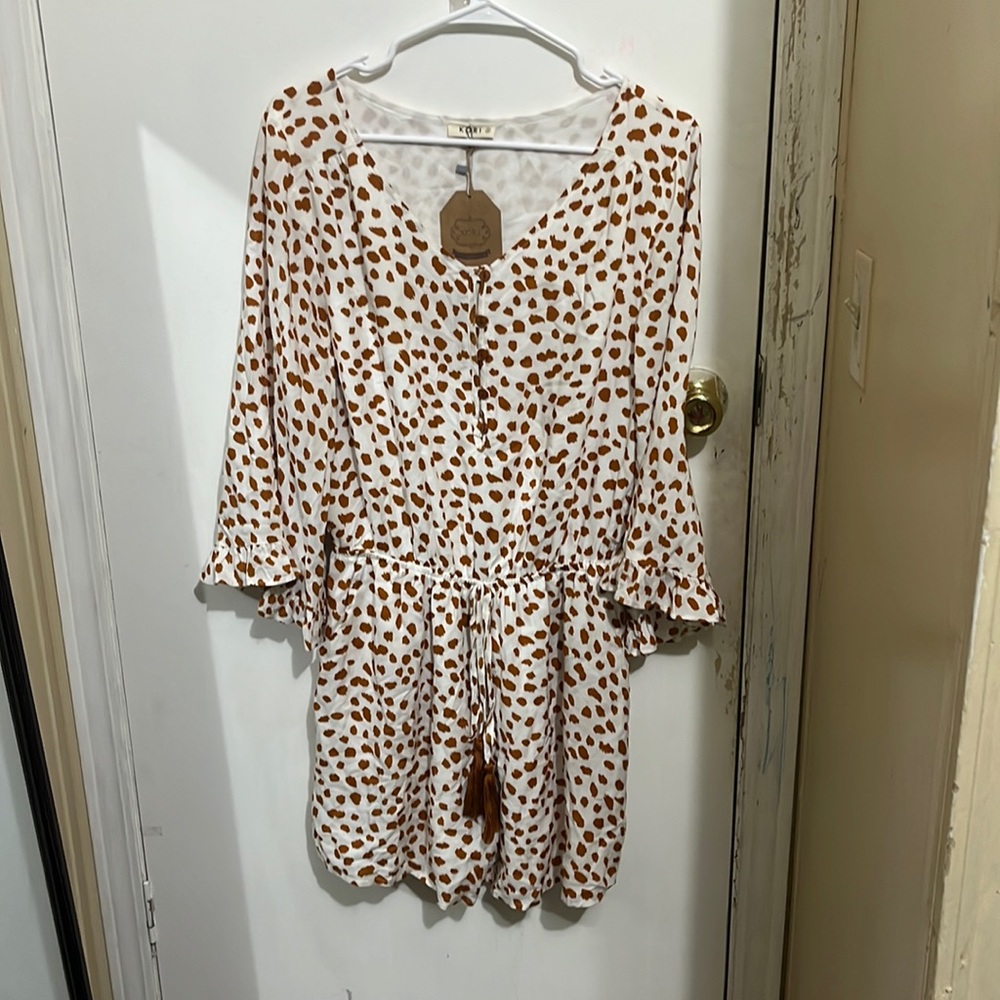 Brand new romper never been worn.Size small but fits like a medium brand Kori.